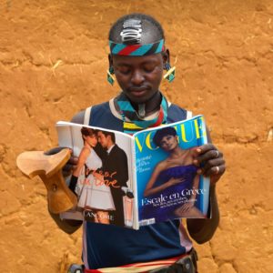 Young Fashionable Banna Man With Headrest Reading Vogue French Magazine Ethiopia