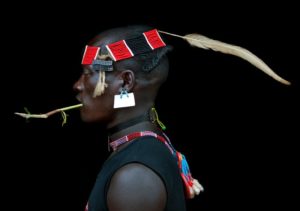 Ethiopia, Omo Valley, Key Afer, Bana Tribe Man Wearing A Headband With Feather, Strass Clips And Sim Card As Earring