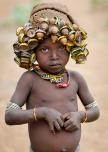 Ethiopia, Omo Valley, Omorate, Dassanech Baby Boy Portrait Wearing Bottle Cap