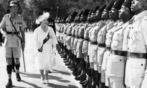 Queen Elizabeth, the Queen Mother accompanied by the guard commander Major R. Aikenhead, inspects a guard of honor of the Second Battalion the Kings African rifles at the great Indaba in the Matotos Hills, near Bullawayo, Rhodesia on July 8, 1957. Behind the Queen Mother is her private secretary, Lt-Col. Gilliatt. The Queen Mother wears a jacket and dress of white lace. Her white hat is trimmed with white and sapphire blue osprey feathers. (AP Photo)